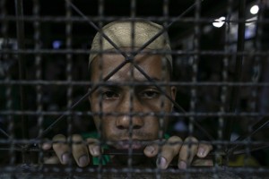 A Rohingya illegal immigrant looks out from an Immigration Detention Centre in Thailand. (Reuters)