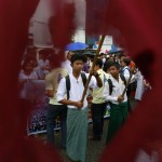 Students march as they wave flags used during the 8888 democratic uprising in Yangon
