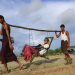 Rohingya men carry a patient to a hospital outside Sittwe