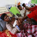 Rohingya men who were shot by the police during a riot on Friday rest in Dapaing district clinic, outside of Sittwe