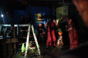 Buddhist monks from Mahasantisukha Monastery in Rangoon’s Tamwe Township are escorted away by officials from the Religious Affairs Department and riot police on the night of 10 June 2014. (DVB)