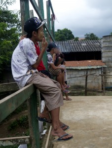 A young boy smokes a cigarette in Mae La refugee camp. With the camp in operation for 30 years, many children have lived their entire lives there. (PHOTO: Dene-Hern Chen)