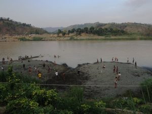 Paletwa residents play football on a new swath of land created by dredging operations to deepen the Kaladan River to allow large 260-ton cargo ships to dock at the new Paletwa inland port. (PHOTO: Kaladan Movement)