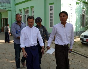 The three defendants, Phil Blackwood (behind), Tun Thurein (left) and Htut Ko Ko Lwin are led to court on 17 March 2015. (PHOTO: DVB)