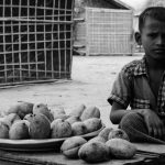 A Rohingya boy sells mangoes in Thet Kae Pyin IDP camp, near Sittwe, Burma.