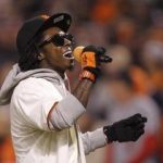 Rapper Lil Wayne sings during the seventh inning stretch in Game 6  of the MLB NLCS playoff baseball series between the St. Louis Cardinals and the San Francisco Giants in San Francisco