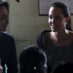 Myanmar pro-democracy leader Aung San Suu Kyi and UNHCR special envoy Angelina Jolie Pitt meet with female factory workers at their hostel in the Hlaingtaryar Industrial Zone in Yangon