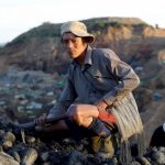 A miner sits in a mine as he searches for jade stones at Hpakant jade mine in Kachin state