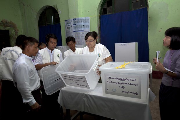 Polling officials present the empty ballot boxes to mark the opening of voting booths in Burma's general election. (PHOTO: DVB)
