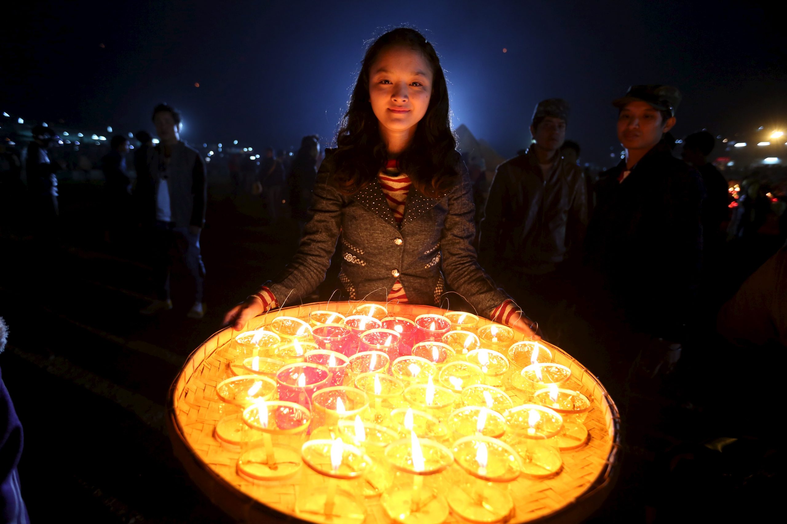 A girl carries candles for lighting traditional home-made paper ...