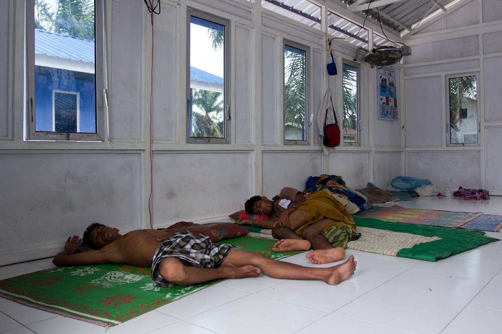 Two Rohingya men take a nap in their room at Bayeun Refugee Camp, in the outskirts of Langsa City (Aceh Province, Indonesia). Photo: Carlos Sardiña Galache / Yayasan Geutanyoe – A Foundation for Aceh.
