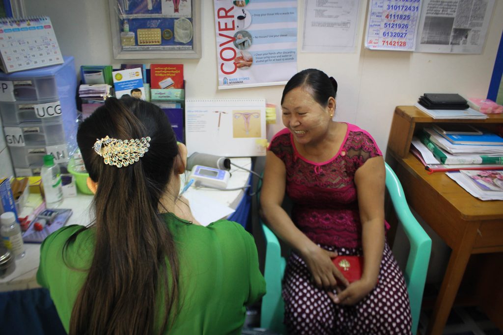 A lady discusses contraceptives with her doctor in a clinic on the outskirts of Rangoon. (Photo: Libby Hogan / DVB)