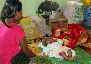 Mother tends to her baby at the monastery in Buthidaung. (PHOTO: DVB)