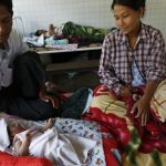 A family looks at their newborn baby in North Dagon township hospital in Yangon