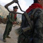 Taang National Liberation Army soldiers stand guard before they destroy a poppy field in Nanbarkyaing village
