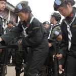 Soldiers check their guns before taking part in Shan State National Day.