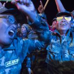 Soldiers rock it out during a closing performance by a local musical group.